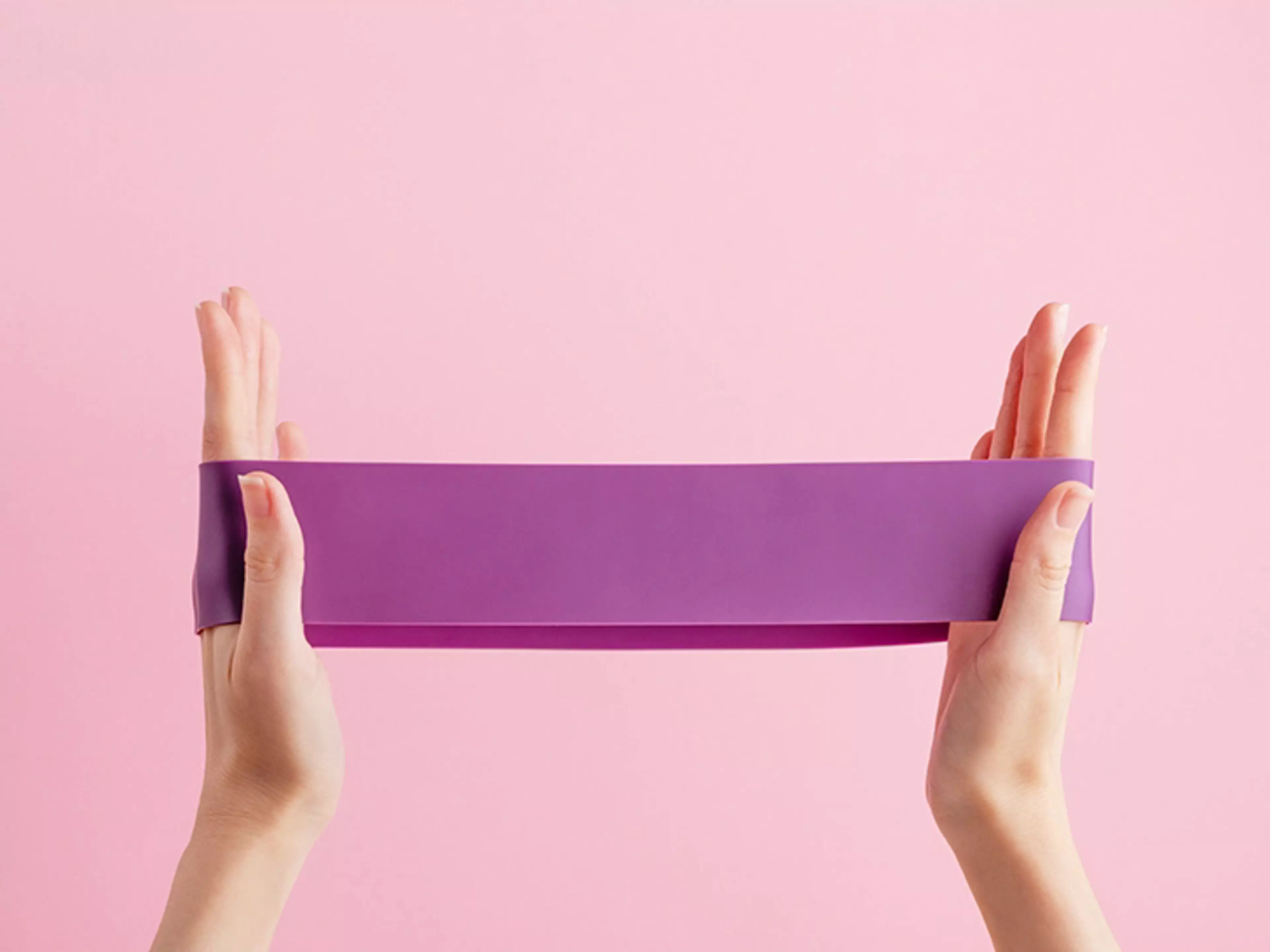 Hands holding a rubber exercise band