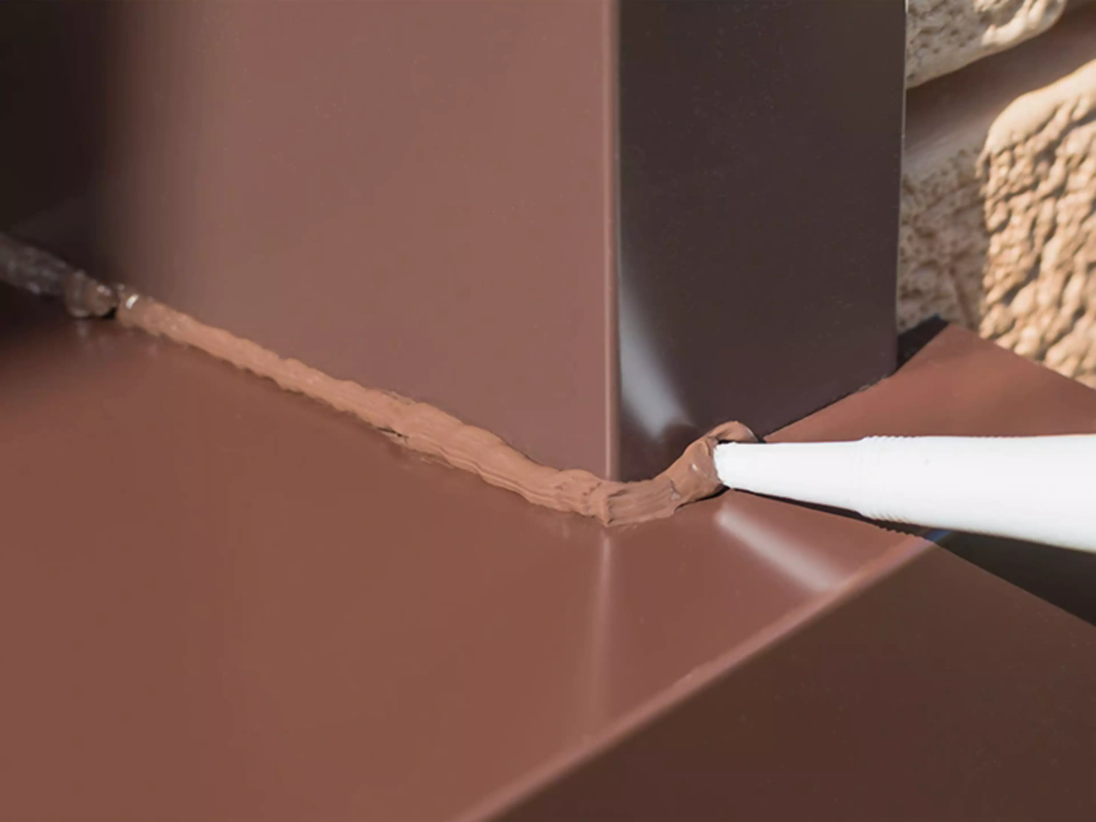Coloured Sealant finishing a brown windowframe