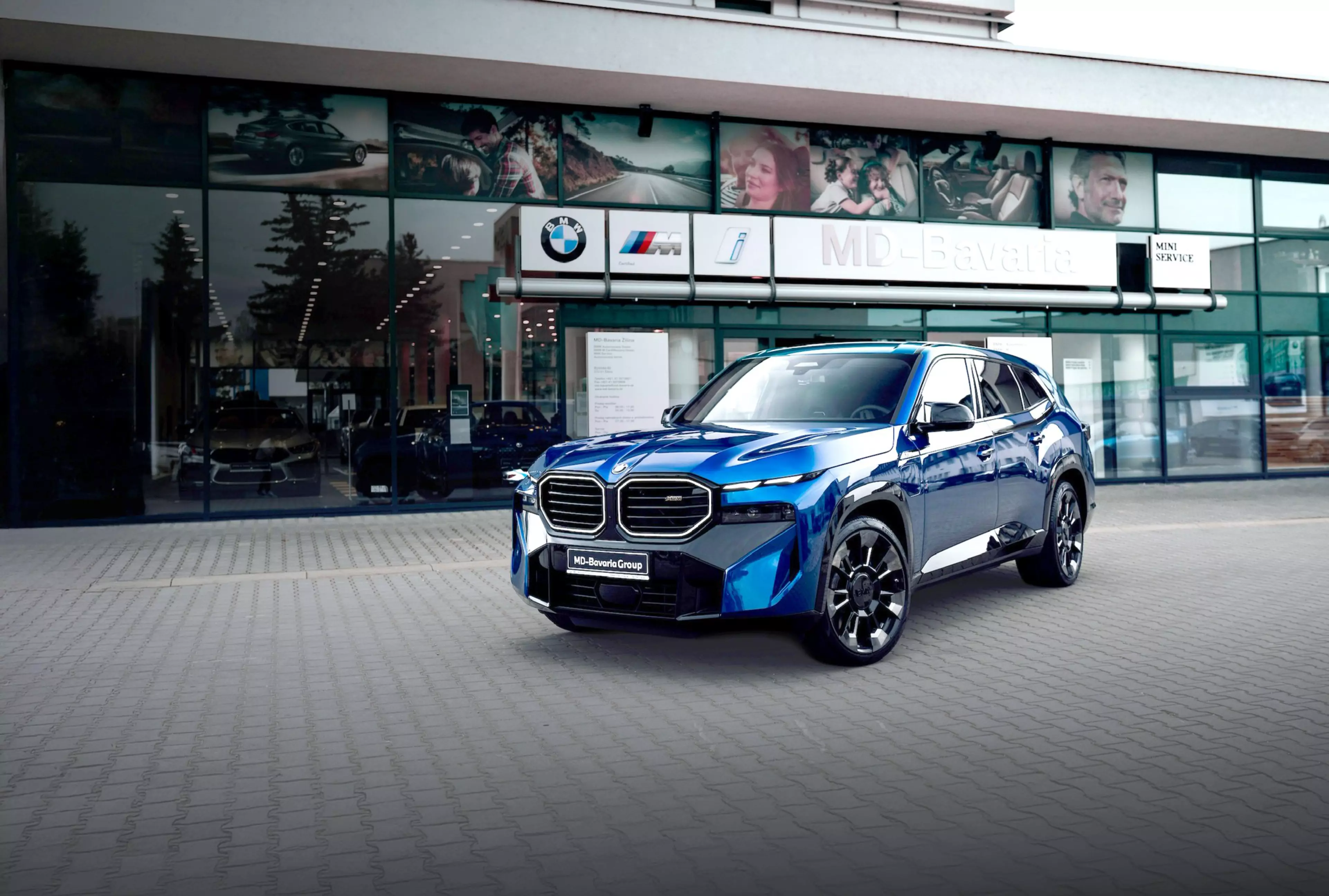 A blue BMW SUV parked in front of the MD-Bavaria BMW dealership