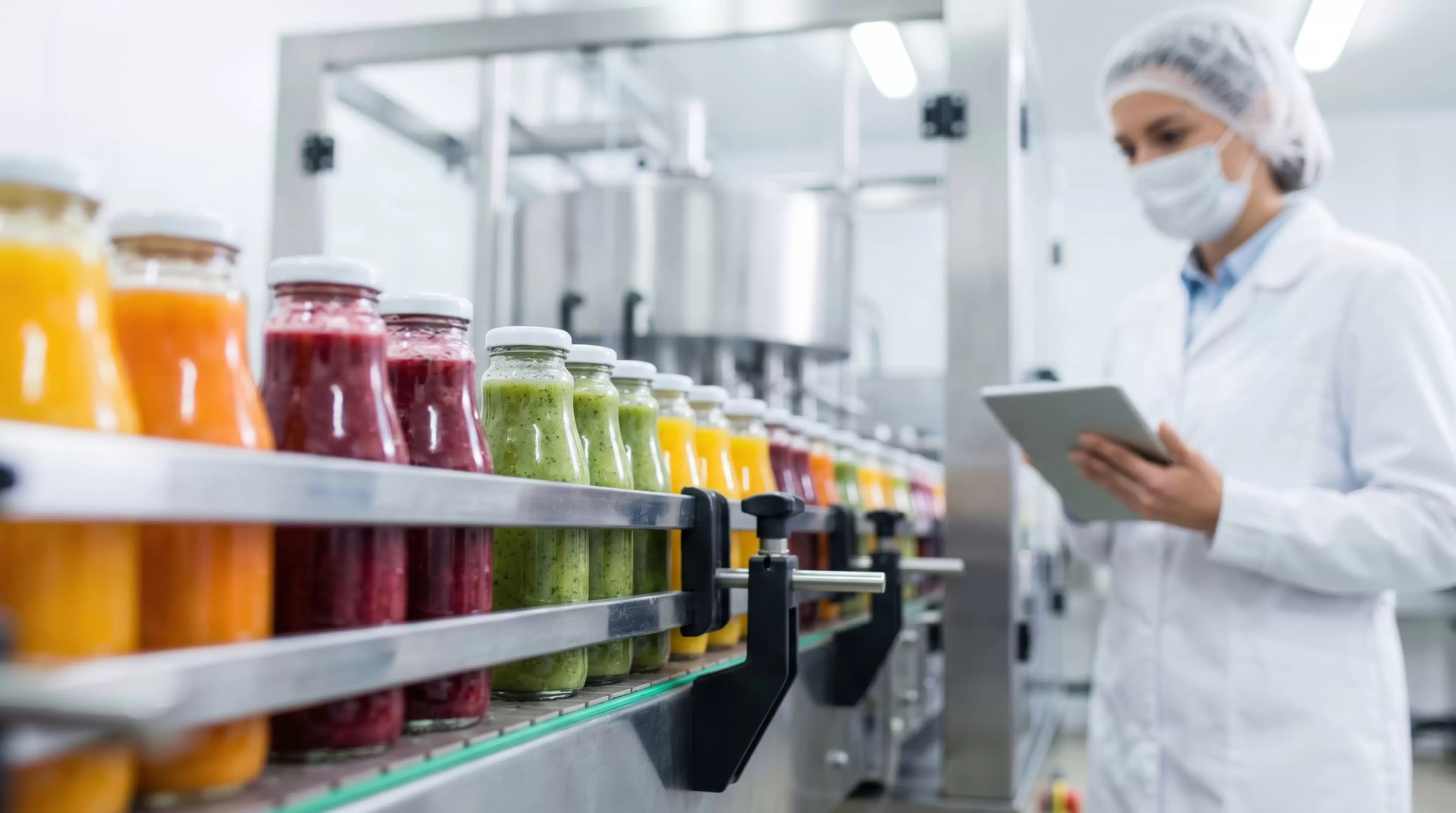 In a juice factory, a worker inspects bottles of various juices on a production line. The worker wears a lab coat, mask, and hairnet while using a tablet to monitor the process.
In a juice factory, a worker inspects bottles of various juices on a production line. The worker wears a lab coat, mask, and hairnet while using a tablet to monitor the process
food, production, industry, juice, factory, worker, bottles, quality, check, lab, coat, tablet, types, manufacturing, mask, hairnet, equipment, assembly, line, daytime, inspection, beverages, fruits, processing, technology, hygiene, workstation, floor, fresh, sweet, fruity, colorful, liquids, machines, bottling, standards, control, efficiency, labor, tasks, supply, chain, monitoring, operations, workflow, staff, process, supplies, inventory, readiness, services, task, management, tool, professional