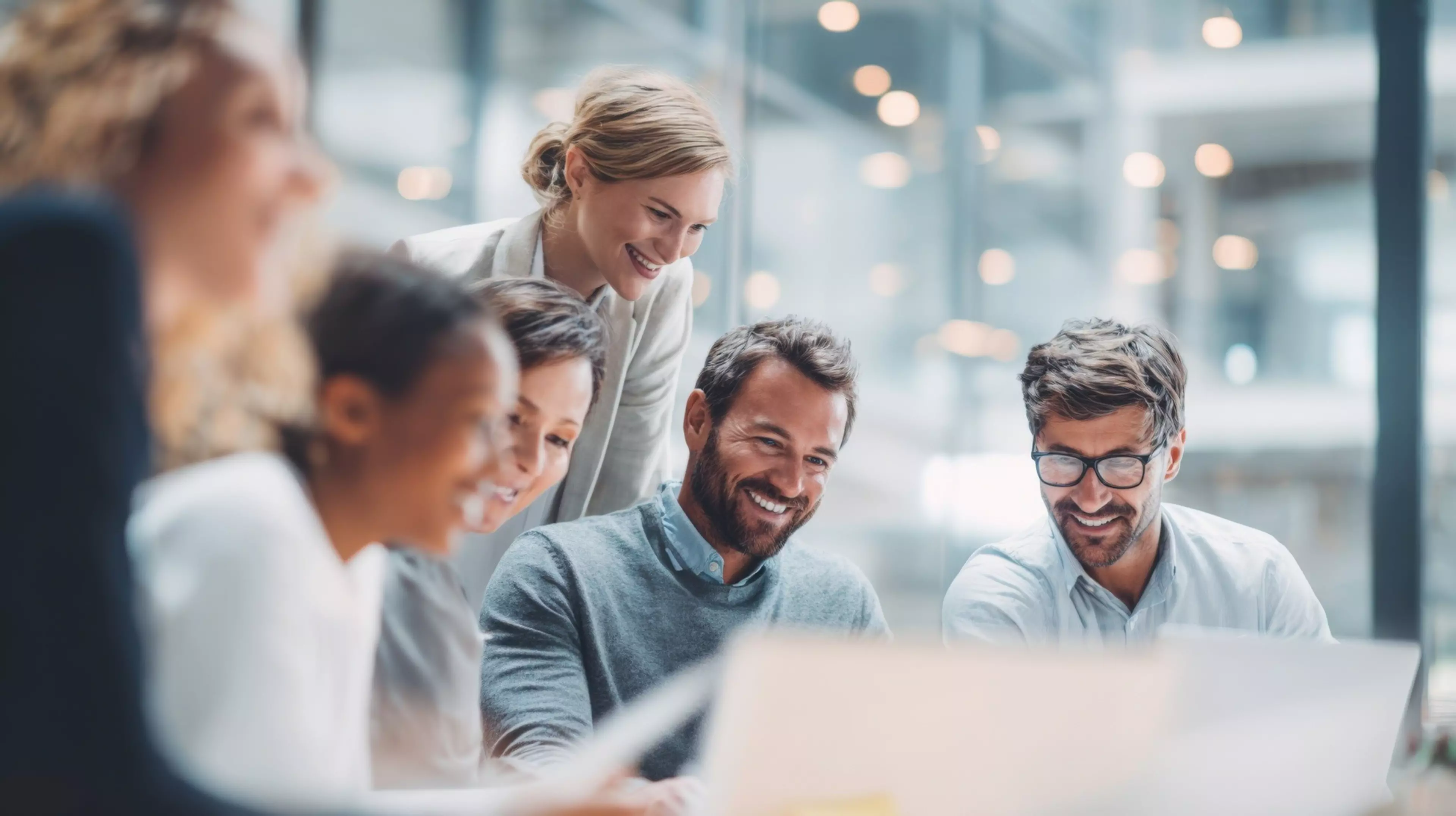 Group of diverse young adults working collaboratively in modern bright office space.
Group of diverse young adults working collaboratively in modern bright office space