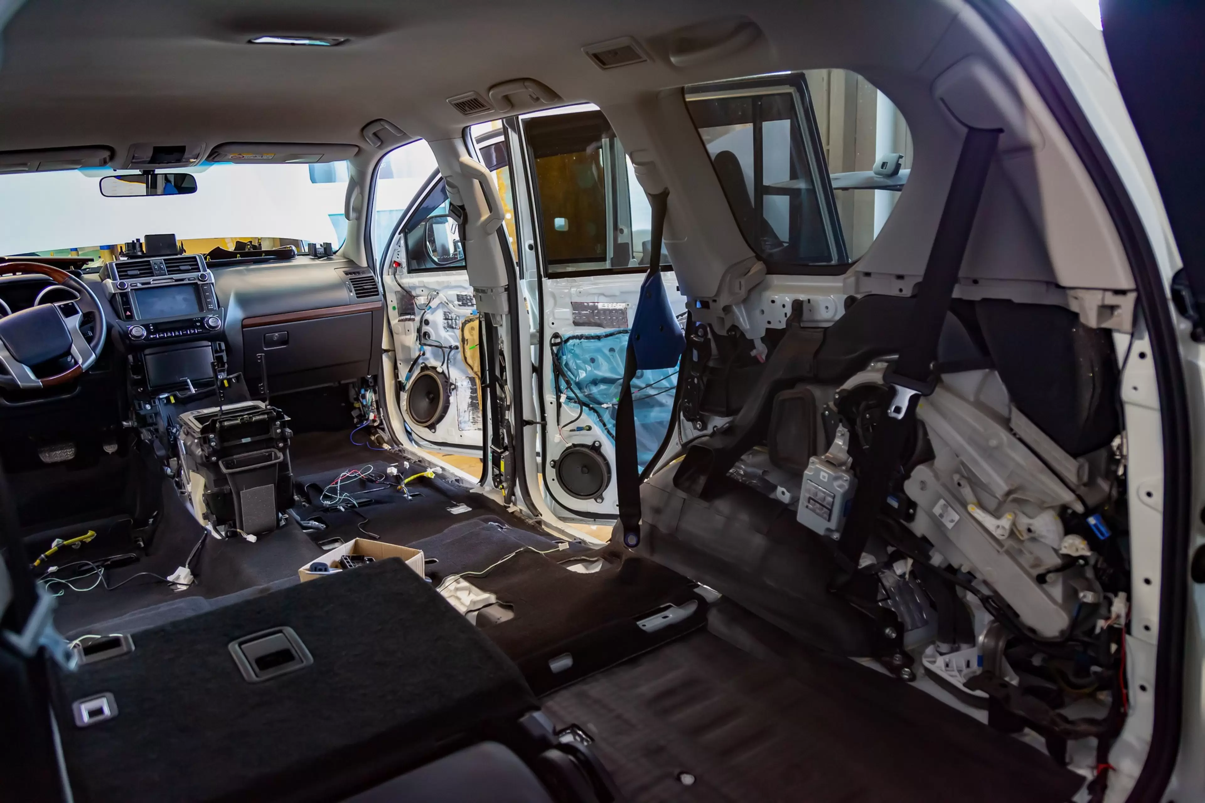 The interior of the SUV inside is completely disassembled, the seats are removed, the flooring and interior are replaced, soundproofing is installed, door panels and trim are missing.
car, vibration, work, service, sound, insulation, background, material, soft, isolation, technology, repair, frame, dismantled, disassembled, vehicle, machine, panel, automobile, automotive, body, nobody, protection, view, spare, steering, inspection, dashboard, reduction, breakdown, disassemble, equipment, wall, station, column, mechanical, toned, workshop, maintenance, transmission, interior, electricity, cable, white, black, crossover, inside, ferreous, steering wheel