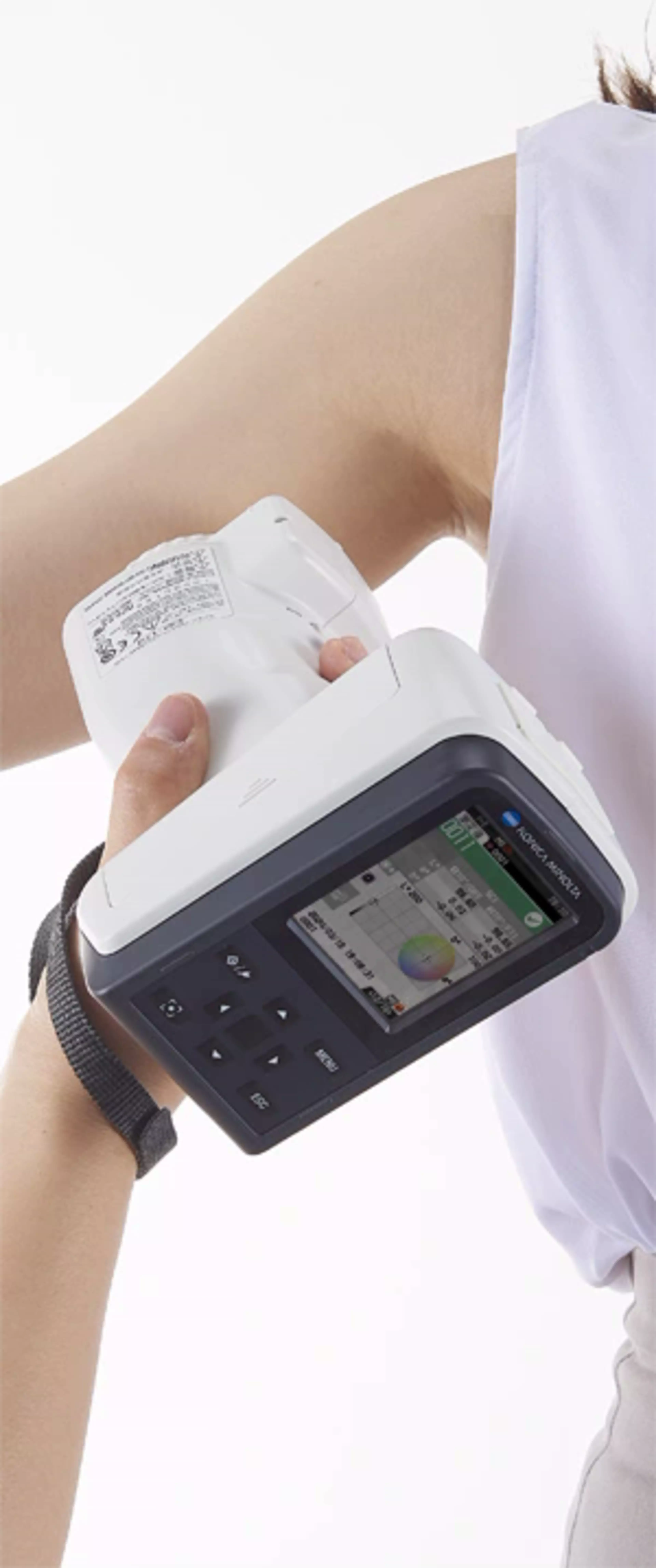 A colour measuring instrument recording the colour of a skin colour measurement on a human arm.