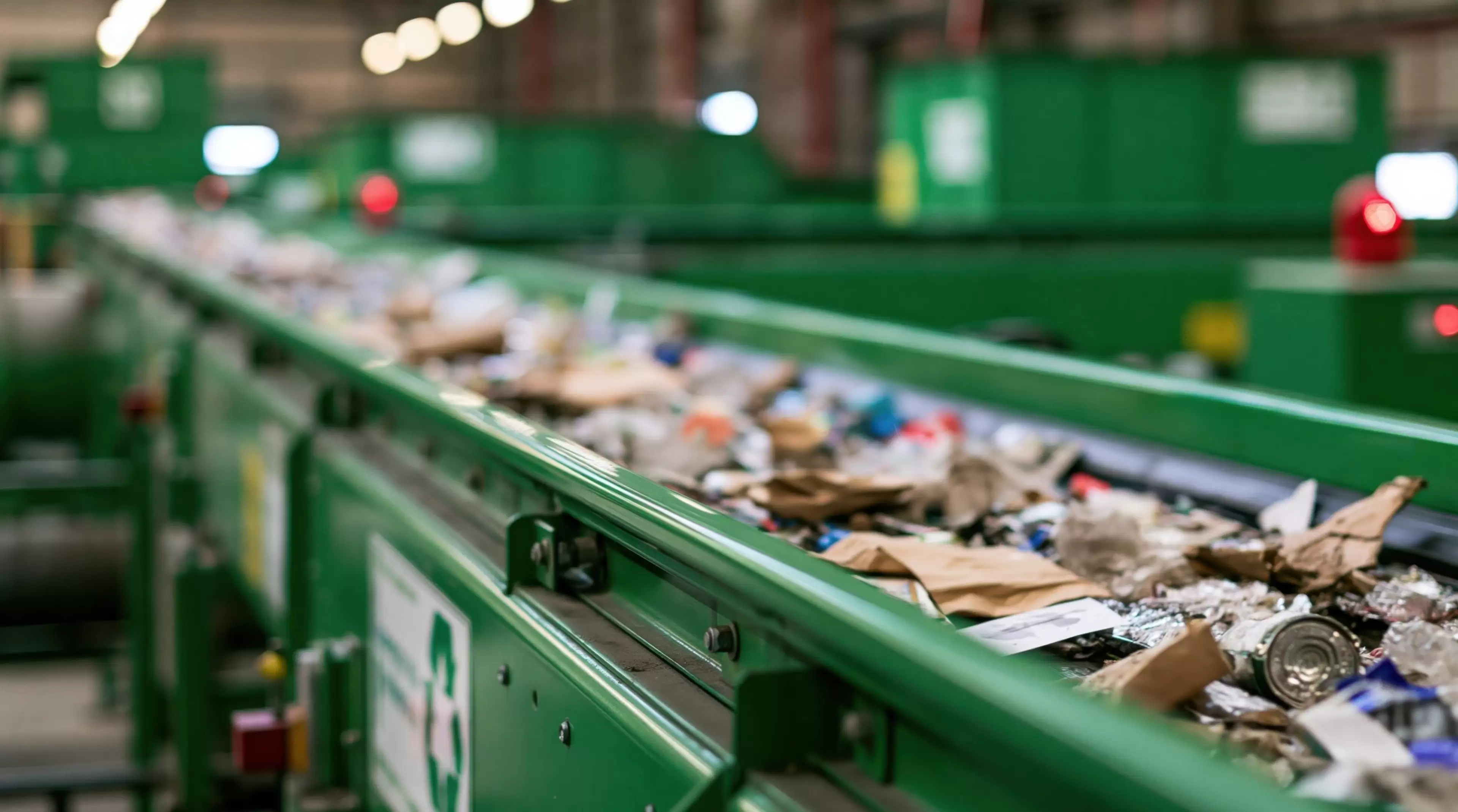 Conveyor belt carrying mixed waste in recycling facility
conveyor belt,waste,garbage,recycling,machine,refuse,sorting,processing,moving,facility,factory,industrial,plant,sustainability,ecology,environment,paper,plastic,can,green,bokeh,close up