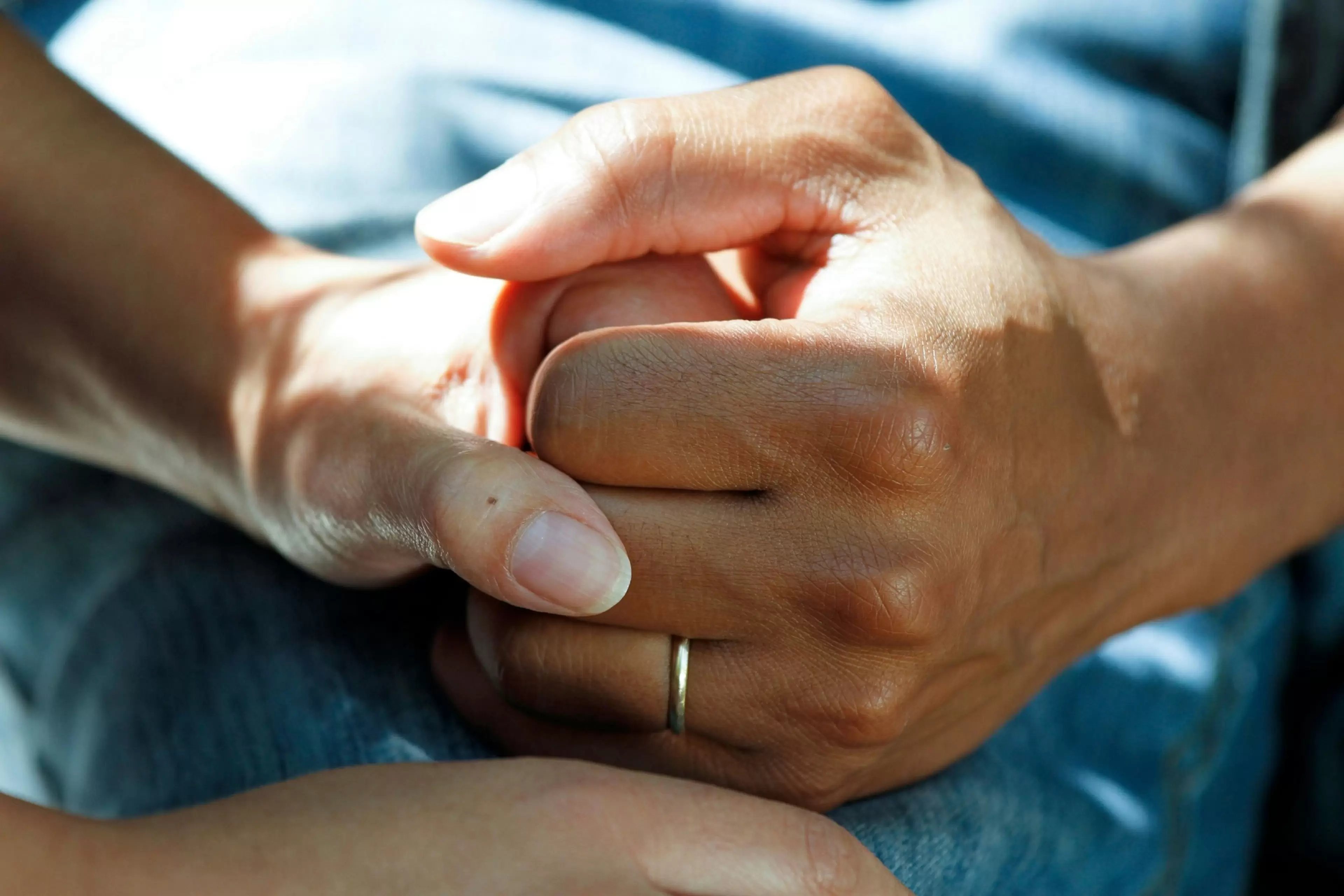 A healthcarer and a patient take their hands