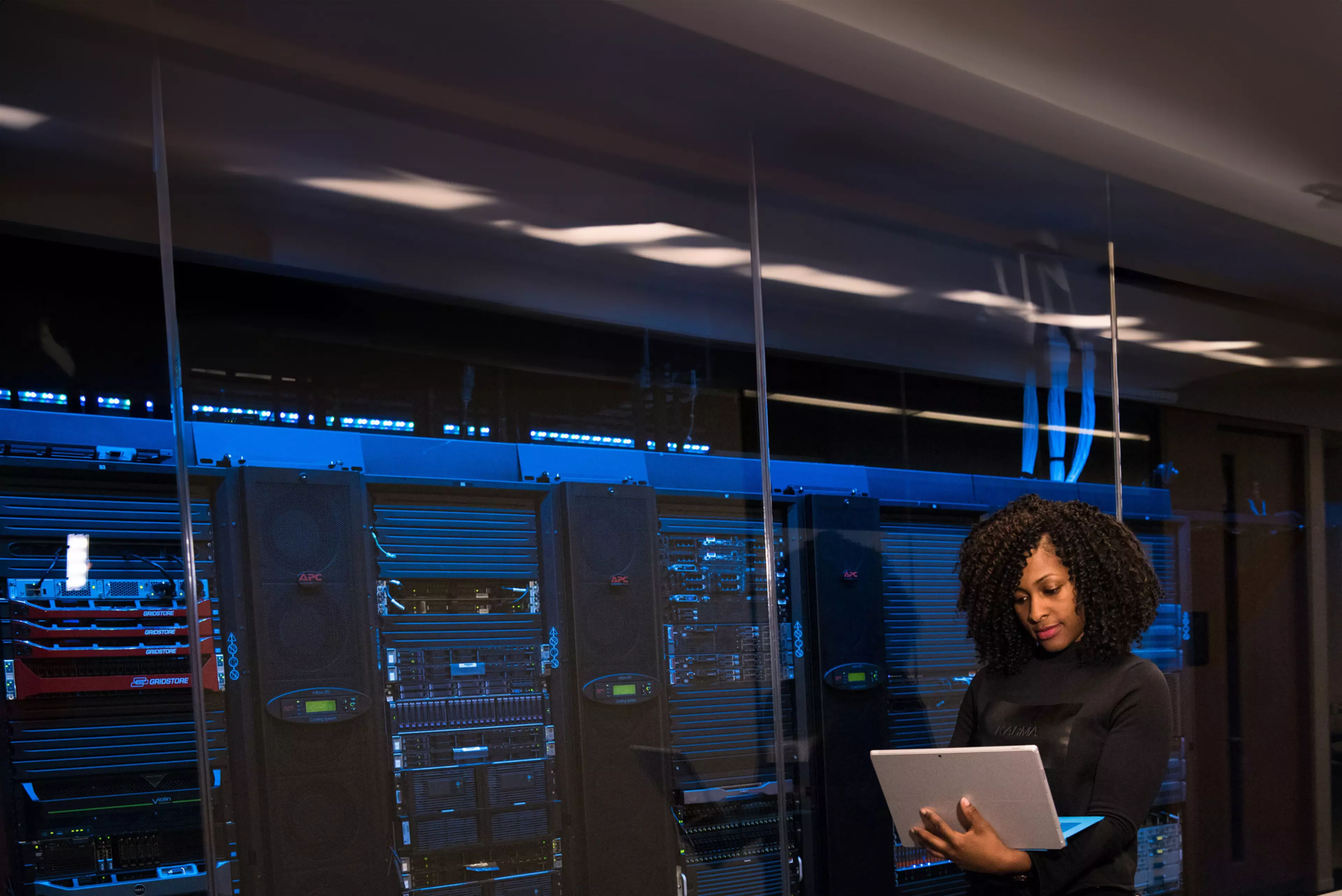 Mujer joven trabajando en una sala de servidores