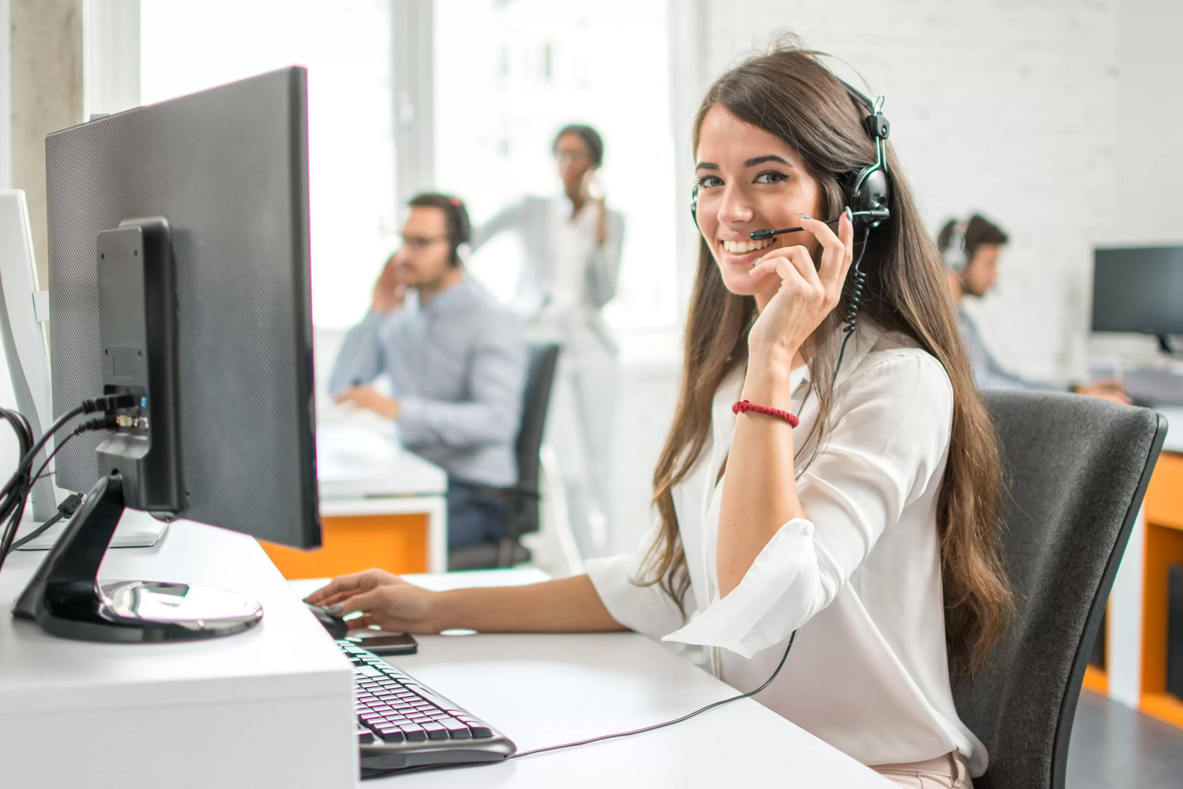 Young friendly operator woman agent with headsets working in a call centre.; Shutterstock ID 712414813; Purchase Order: CorpCom; Job: ; Client/Licensee: ; Other:
adult,  agent,  beautiful,  business,  businesswoman,  call,  caucasian,  center,  centre,  cheerful,  client,  communication,  computer,  consultant,  contact,  corporate,  customer,  female,  friendly,  girl,  group,  happy,  headphone,  headset,  help,  helpdesk,  job,  office,  operator,  people,  person,  phone,  portrait,  professional,  receptionist,  representative,  service,  smiling,  support,  team,  teamwork,  technology,  telemarketing,  telephone,  woman,  work,  worker,  young,  technical support