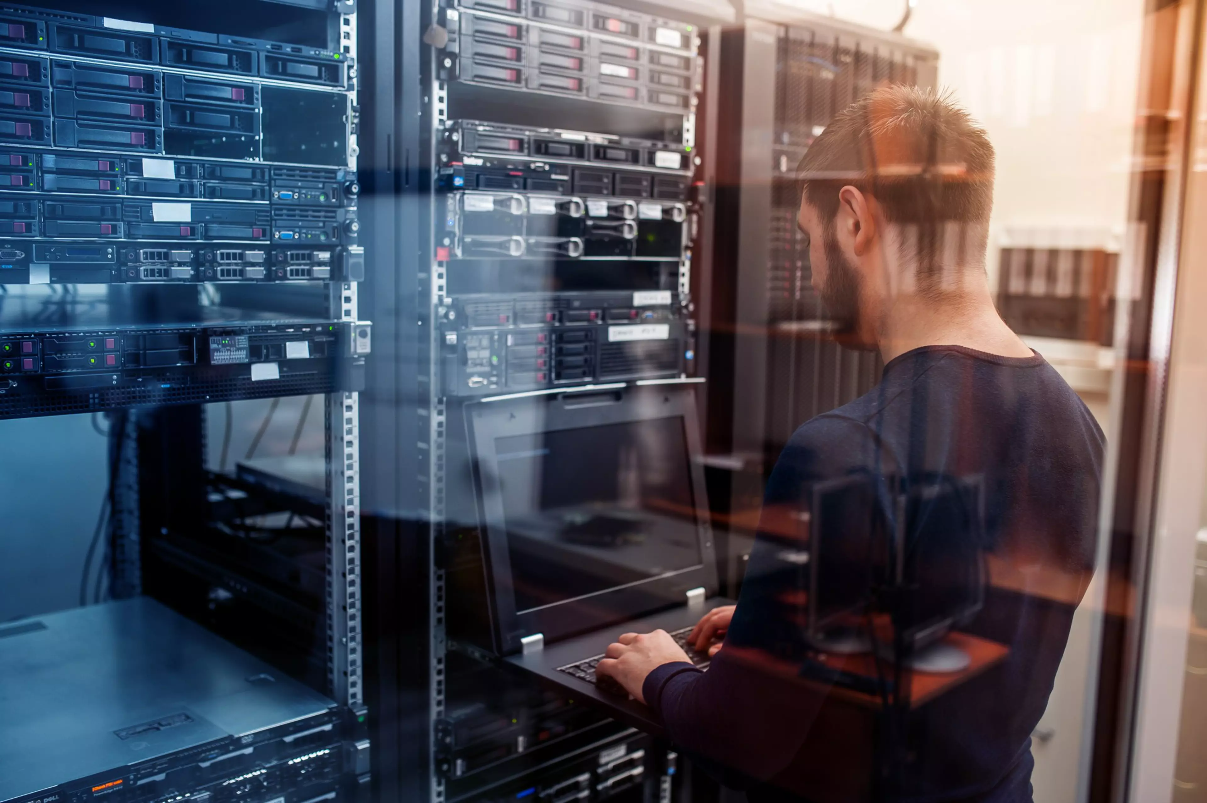 young it engeneer business man with thin modern aluminium laptop in network server room; Shutterstock ID 574000213