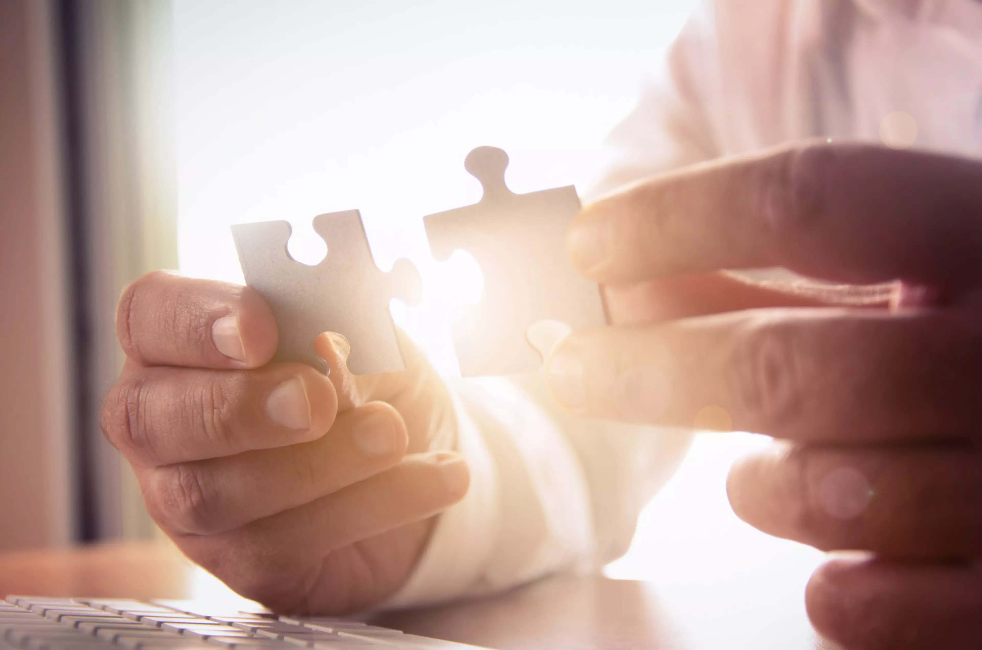 Business solutions, success and strategy concept. Businessman hand connecting jigsaw puzzle. ; Shutterstock ID 313786025; PO: Corpcom