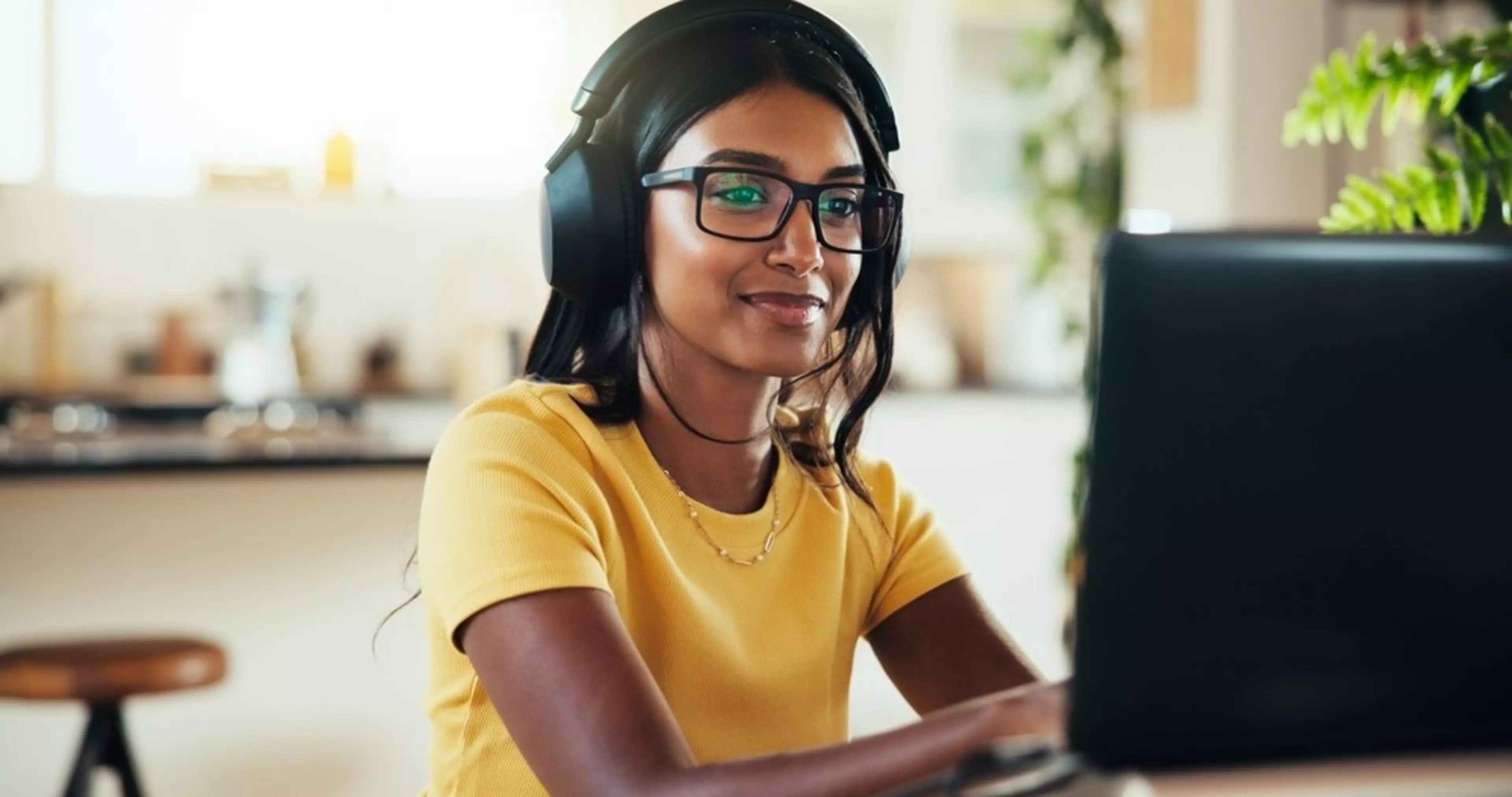 Laptop, music and web design with Indian woman in home office for for marketing campaign or remote work. Computer, headphones and smile with happy freelance employee in apartment for publication
2585087577