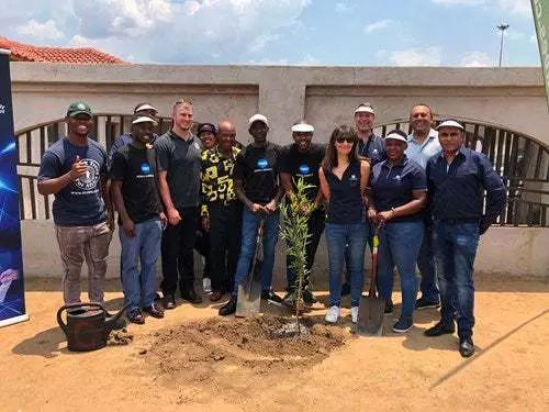 Representatives from Konica Minolta SA, FTFA and Mr France Mphele, sharing a sense of excitement following the planting of a tree outside the former home of Nelson Mandela in Orlando East

