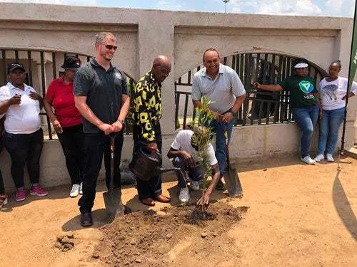 Chris Wild, Executive Director FTFA, Mr France Mphele, current owner of Nelson Mandela’s former family home, Mr Lebo Mphele, son of France Mphele, Marc Pillay, CEO Konica Minolta SA, planting a tree outside the home where Nelson Mandela formerly resided.